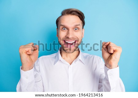 Photo of happy amazed young man crazy mood achieve success winner isolated on pastel blue color background