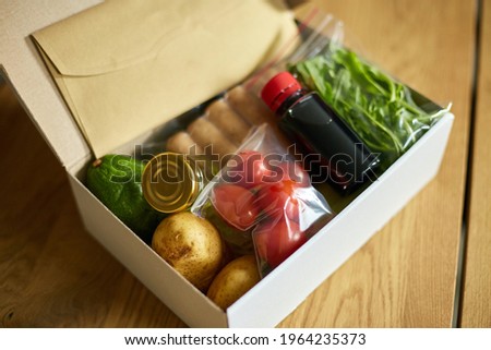Food box meal kit of fresh ingredients and recipe blank order from a meal kit company, delivered, cooking at home. Royalty-Free Stock Photo #1964235373
