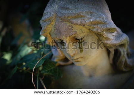 Death concept. Angel crying as symbol of pain, fear and end of human life. Fragment of an ancient statue.