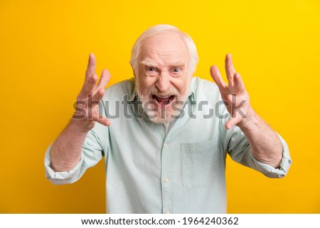 Photo of annoyed outraged mature man dressed green shirt rising arms isolated yellow color background Royalty-Free Stock Photo #1964240362