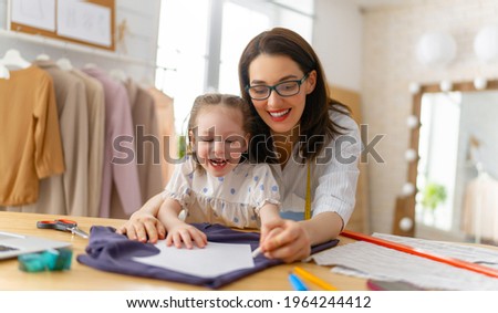 Woman is working at home workshop. Concept of small business. Mother and daughter.
