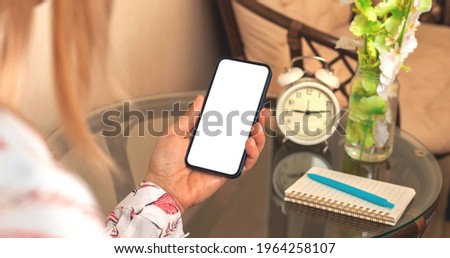 Feminine smartphone mockup, woman hold smartphone with blank white screen, beautiful and elegant background