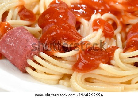 Close-up image of hot dog skewers and spaghetti with tomato ketchup
