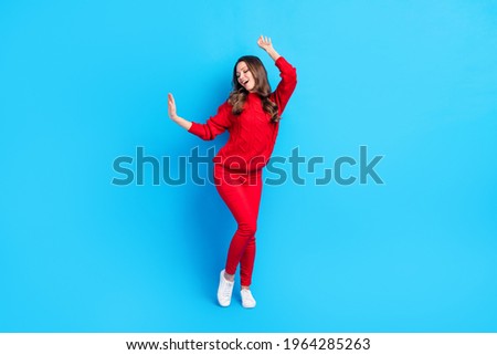 Full size photo of young girl happy positive smile have fun enjoy music dance isolated over blue color background