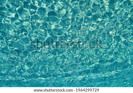 Background of underwater. Rippled blurred texture of water. Blue water surface.