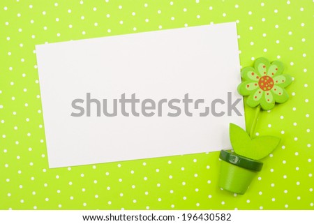 Fake flower in polka dots background and white paper 