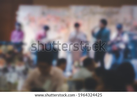 Abstract blurred background of master of ceremonies with microphone on stage