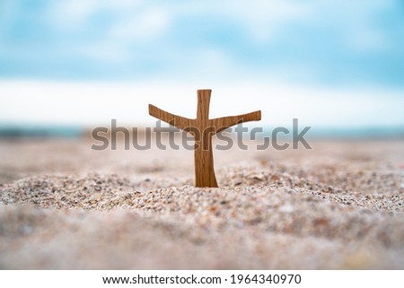 A wooden cross on the sand on the beach of Korea