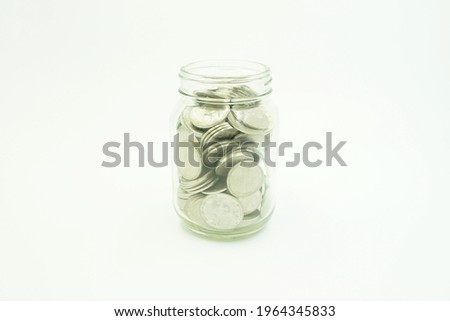 One jar full of coins isolated on a white background