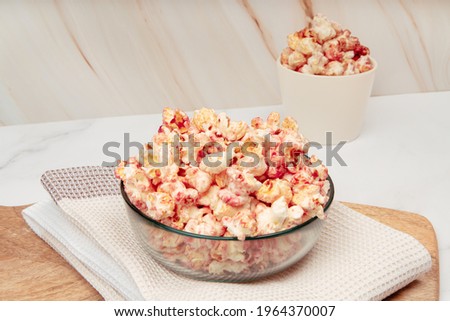 Marble table with glass bowls and ceramics with pink popcorn