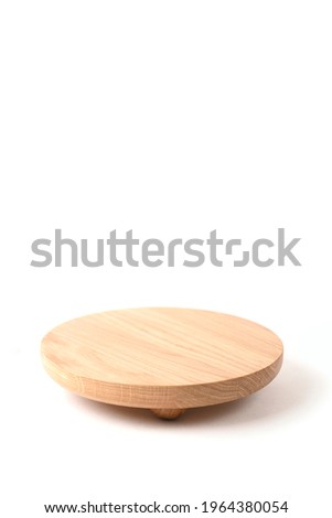 Round wooden podium on white background for product presentation. Front view. Copy space. Vertical