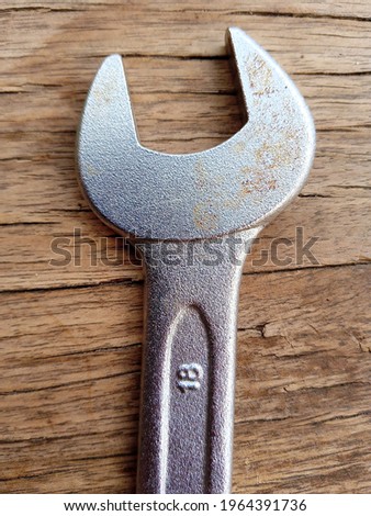 Wrench on wood background, hand tool, Size 18