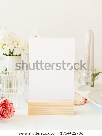 Mock up label the blank menu frame in bar restaurant, Stand for booklets with white paper, wooden tent card on restaurant table