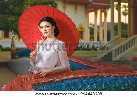Beautiful Thai girl in traditional dress costume. Asian women wearing indigenous costumes in traditional Thai culture, vintage style.