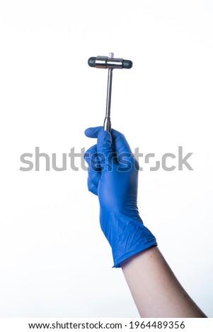 podiatrist wearing gloves holding a reflex hammer
