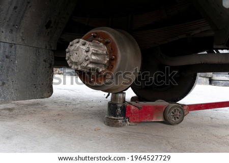 Truck change wheels using a lifting jack. Royalty-Free Stock Photo #1964527729