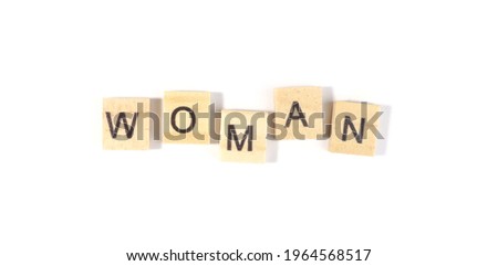 Top view, Woman the alphabet on the wooden tile pieces scraped square. Isolated on white background