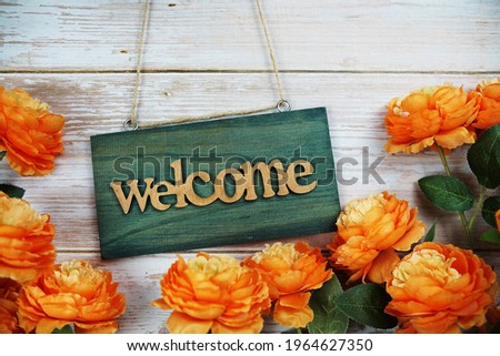 Welcome sign hanging on wooden with flower bouquet decoration
