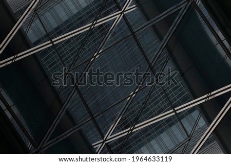 Glass wall with reflections of high-rise buildings. Closeup photo of skyscrapers in business or financial city center. Modern architecture of glass towers. Polygonal and checkered geometric background