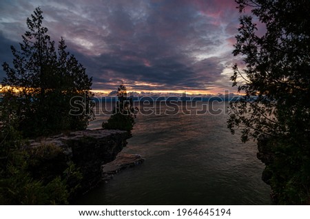 Sunrise lights up the Lake Michigan shore at Cave Poimt County Park, Door County, Wisconsin