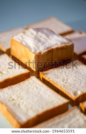 The slices of toast bread filling the picture are spread out on the table