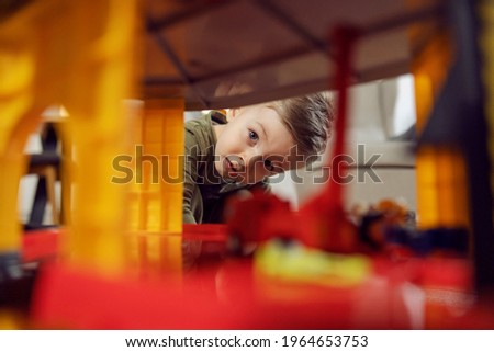 The boy explores while playing. A picture of a baby boy playing with toys indoors. A happy childhood in kindergarten, child development. Kids education in daycare, playing a game and growing up