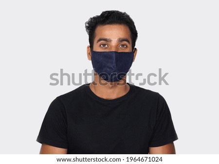 Man with Covid mask watching camera