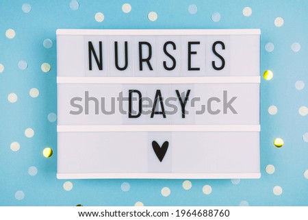 Lightbox with an inscription on a blue background. Greeting card for International Nurse Day. Medical background