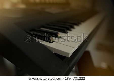 blurry image,Piano placed in the living room So that the family can rest Or doing activities together.