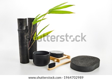 Skin and tooth cleansing and detox. Bamboo charcoal powder cosmetics on white background