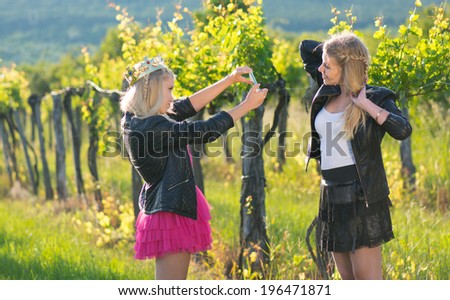 two young women and twins taking selfie with mobile phone