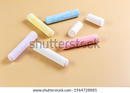Colored crayons on a beige background. Child Game. Hobby. Child development and leisure concept. Copy space. High quality photo