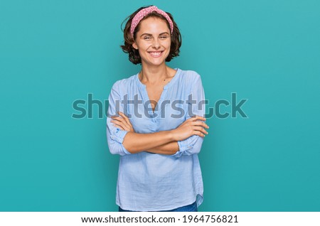 Young hispanic woman wearing casual clothes happy face smiling with crossed arms looking at the camera. positive person. 