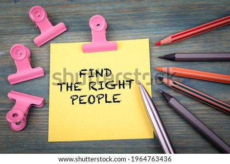 Find The Right People. Note sheet and office supplies on a green wooden background.