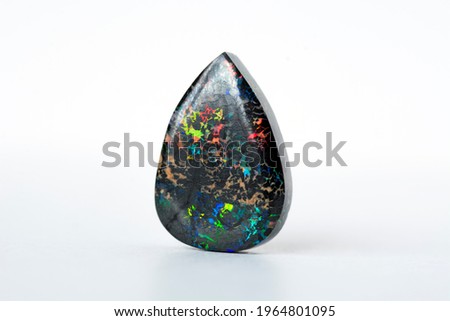 Mined from Queensland fields solid black matrix boulder opal. Red, orange, green, yellow, amber, violet and turquoise color veins play. Ironstone treated, carbonated  to darken and stabilized. 