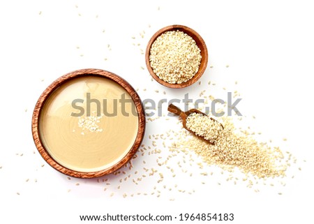 Homemade tahini or tahina, paste from ground sesame seeds  isolated on white, top view Royalty-Free Stock Photo #1964854183