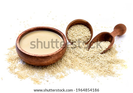 Homemade tahini or tahina, paste from ground sesame seeds  isolated on white, top view Royalty-Free Stock Photo #1964854186