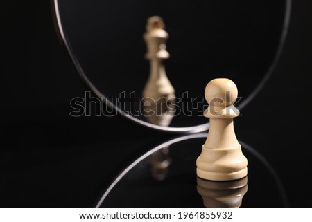 Pawn feeling itself like queen, chess piece in front of mirror. Self-appraisal, alter ego, true personality concepts