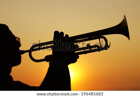 Silhouettes of trumpet player
