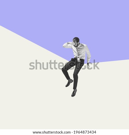 Man sitting on angle on geometrical background. Modern design, contemporary art collage. Inspiration, idea, trendy urban magazine style. Negative space to insert your text or ad. Surrealism.