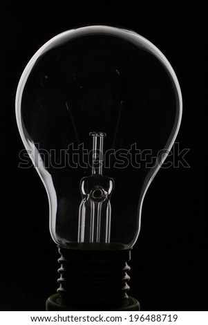 Light bulb turned off over black background 