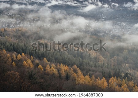 View of a small town among the mountains surrounded by mist