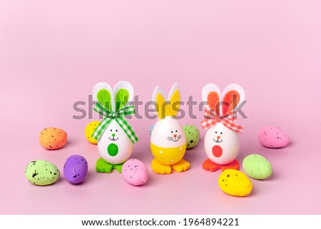Easter eggs cute bunny and colorful quail eggs on trendy pink background Funny decoration Happy Christian Easter celebration Handmade concept Springtime