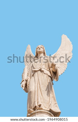 Cover page with statue of winged angel at Evangelical church Saint Nikolai with copy space for text and blue sky as solid background, Potsdam, Germany. Concept of religious and historical heritage