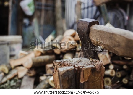 Big ax with chopped woods blurred on background