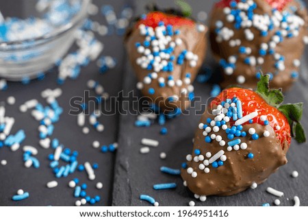 macro photo of chocolate covered strawberries with blue sprinkles