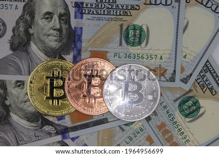Columbus Ohio April 5, 2021
Bitcoin crypto currency with one hundred dollar bills US currency. Royalty-Free Stock Photo #1964956699
