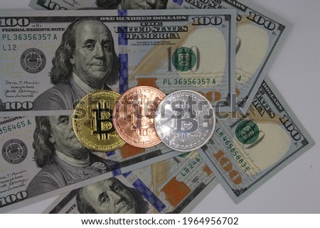 Columbus Ohio April 5, 2021
Bitcoin crypto currency with one hundred dollar bills US currency. Royalty-Free Stock Photo #1964956702