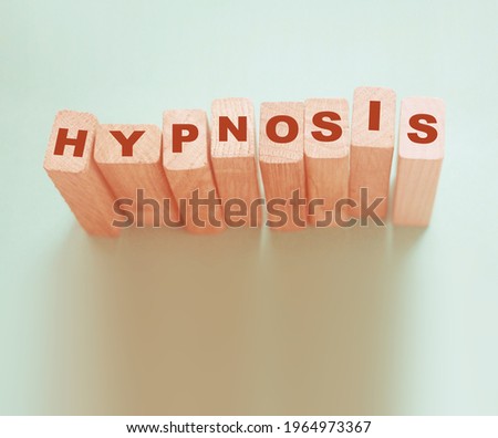 HYPNOSIS word on wooden blocks. Psychology hypnotherapy concept.