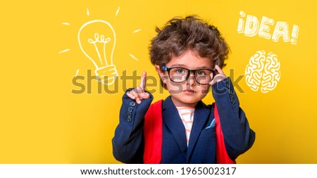 Small smart child in glasses with bag isolated on yellow. Little genius student thinking with lightbulb and math formulas. Student has idea. Pupil with picture of brain. Kindergarten kid go to school.